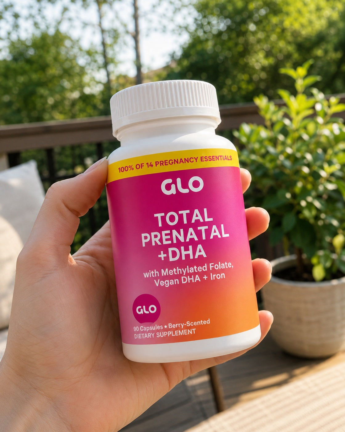 GLO Total Prenatal + DHA bottle held in sunlight