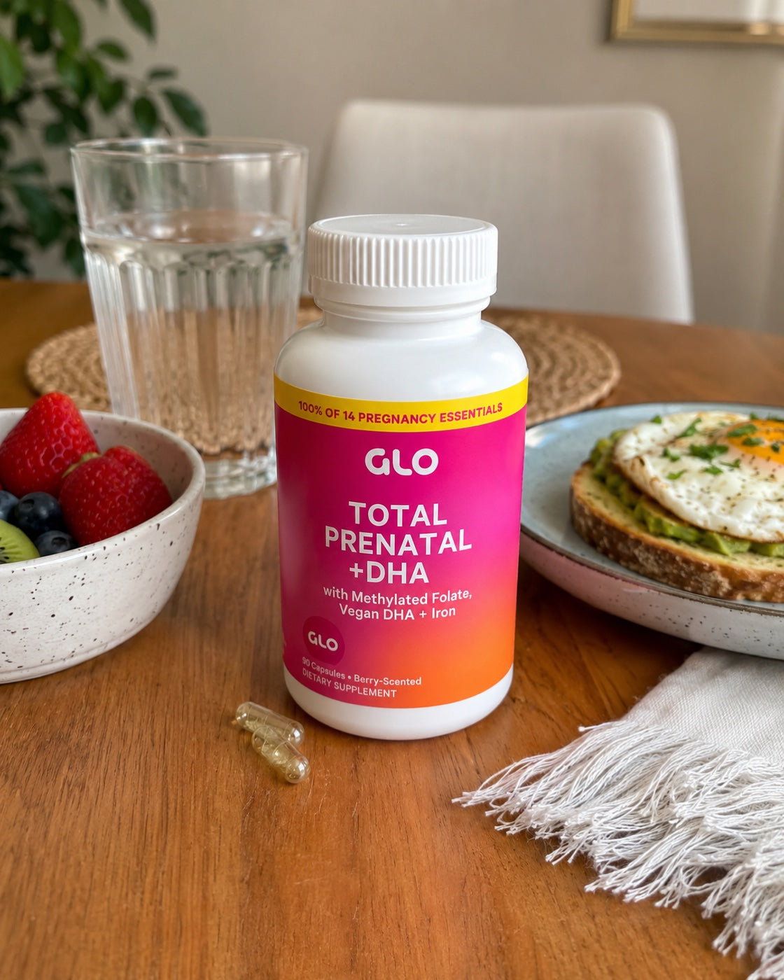 GLO Total Prenatal on a breakfast table with water and berries