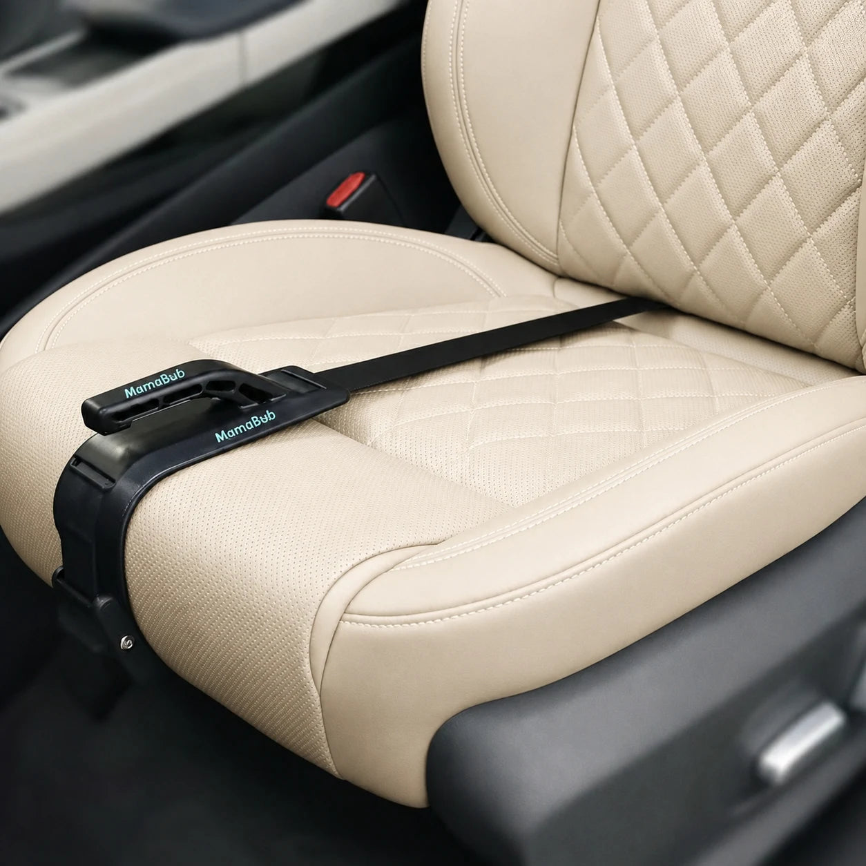 Mama Bub pregnancy seatbelt adjuster installed on beige leather car seat